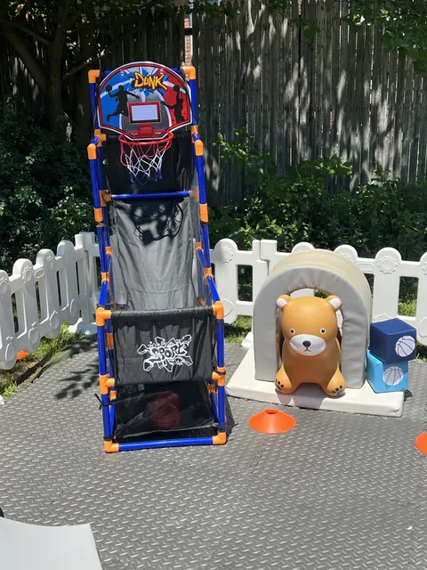 Sports themed setup with a kids basketball hoop and foam arch